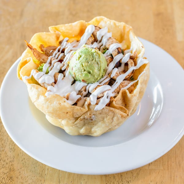 El Chubasco's taco salad with chicken, guacamole, and sour cream in a crispy tortilla bowl.